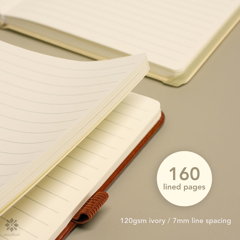 May include: A brown leather bound journal with 160 lined pages. The pages are ivory colored with 7mm line spacing. The journal is open to show the lined pages.