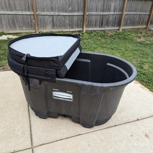 May include: A black plastic storage container with a black and gray lid. The container has a label that reads "Rubbermaid Commercial Products".