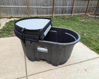 May include: A black plastic storage container with a black and gray lid. The container has a label that reads "Rubbermaid Commercial Products".
