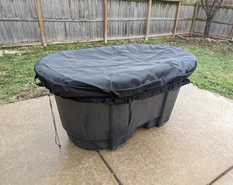 May include: Black oval-shaped hot tub cover with a drawstring closure. The cover is made of a thick, durable material and is designed to protect the hot tub from the elements.