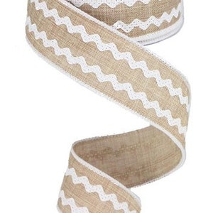 May include: A roll of natural burlap ribbon with a white zigzag pattern. The ribbon is unwound, revealing the textured weave and decorative edge. The ribbon is approximately 2.5 inches wide.