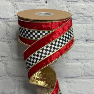 May include: A spool of wired ribbon featuring a central black and white checkered pattern flanked by deep red velvet-textured edges. The ribbon is finished with thin gold metallic trim along both sides and has a gold-colored metallic underside.