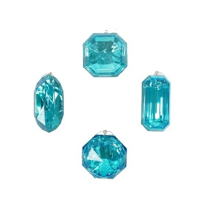 May include: Four turquoise-colored, faceted crystal ornaments in various shapes: an octagon, a rectangle, a long oval, and a round shape. Each ornament has a silver-colored loop for hanging. The crystals are transparent and reflect light.