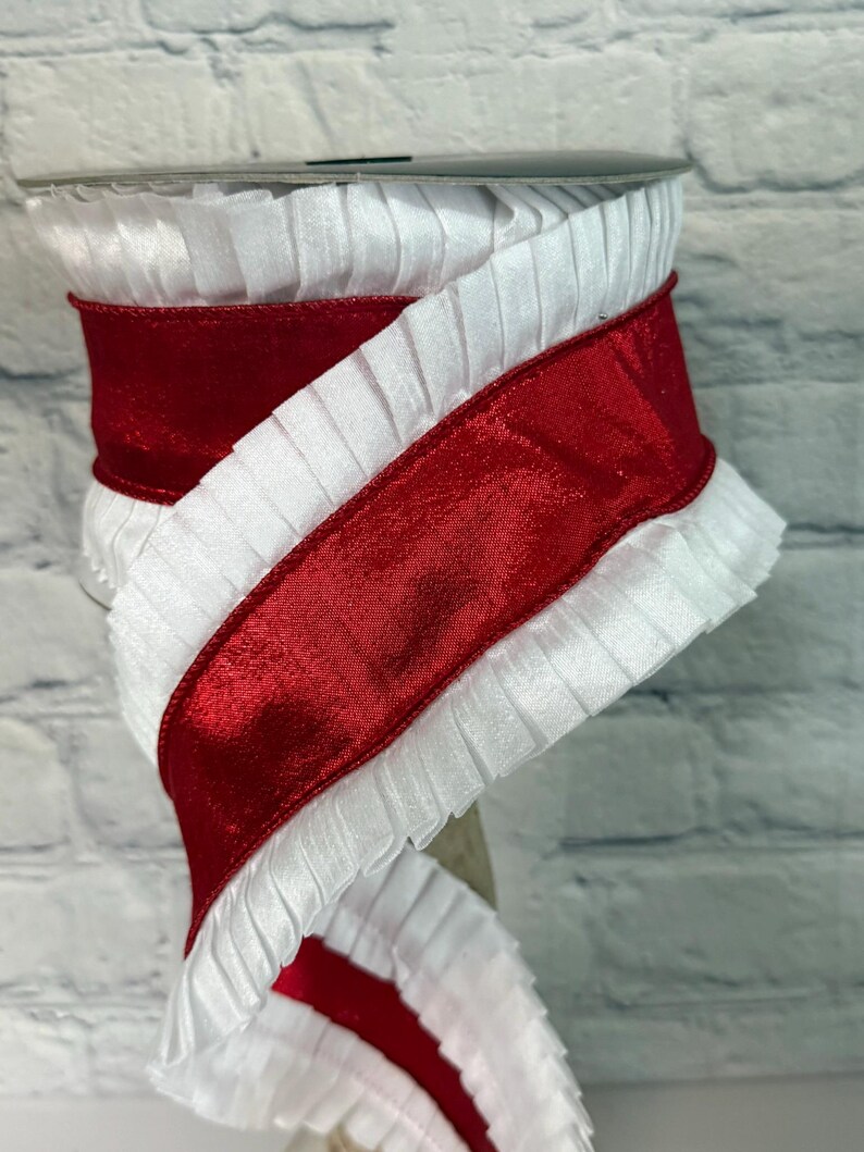May include: A spool of white pleated ribbon with a vibrant red satin ribbon overlay. The ribbon is tightly wound, showcasing the contrasting textures and colors. Ideal for crafting, gift wrapping, or decorative purposes.