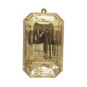 May include: A large, clear, plastic, emerald-shaped ornament with a gold-colored top loop.