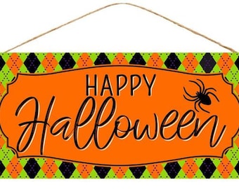 May include: A rectangular Halloween sign with an orange center and a green and black argyle pattern border. The sign reads "HAPPY Halloween" in black script, with a black spider graphic. A brown string is attached for hanging.