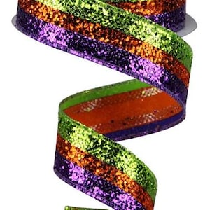 May include: A roll of decorative ribbon with a glittery finish. The ribbon features horizontal stripes of green, orange, and purple. The ribbon is unrolled, showing the colors and texture. This ribbon is suitable for crafts and gift wrapping.