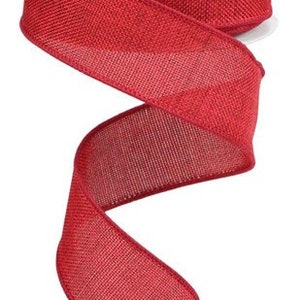 May include: Red burlap ribbon with a textured weave. The ribbon is rolled on a white spool.