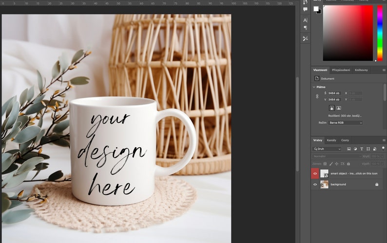 May include: White ceramic mug with a black handwritten inscription that reads "your design here" on a white surface with a beige crocheted coaster. A wicker basket is in the background.