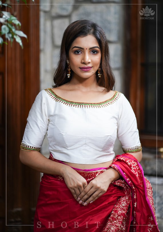 white blouse with gold accents