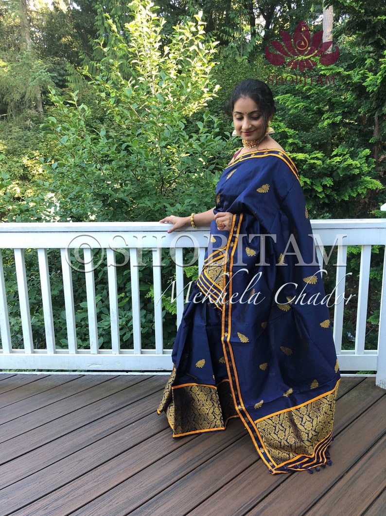 assamese designer dress From Assam, with love.  This is the Mekhela Chador  Assam's traditional  two-piece drape, handwoven in luxurious Assamese silk with intricate Buna  (zari) threadwork. Every weave carries stories of heritage, skill,