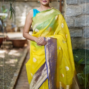Red Budget Silk Saree, Subtly Enriched with Zari Buttas All Over Its Body, Complemented by a Contrast Traditional Zari Design Border, Pallu Mirrors Traditional Zari Designs, and Paired with a Contrast Blouse