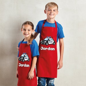Spersonalizowany, wodoodporny fartuch dziecięcy Any Name Police Car. Craft Bake Cook. Chłopcy, dziewczęta. Spersonalizowany śliniaczek. Niemowlę, kucharz junior. 8 kolorów.