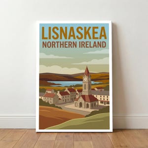 May include: A framed art print featuring a vintage travel poster design for Lisnaskea, Northern Ireland. The artwork depicts a town with a clock tower, red-roofed buildings, and a lake in the background, all under a blue sky.