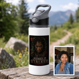 May include: A white water bottle with a grey lid and handle, featuring a rectangular graphic of a dark-skinned warrior with braided hair and the text JUNGLE STALKER THE HUNT BEGINS. A small inset photo shows a person wearing a denim jacket.