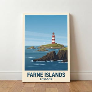 May include: A framed print depicting the Farne Islands in England. A red and white striped lighthouse stands on a small island surrounded by dark blue sea. The image includes the text "Farne Islands England" at the bottom, set against a cream background.