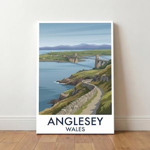 May include: A framed print featuring a scenic view of Anglesey, Wales. The artwork depicts a bridge spanning a body of water, with a winding road along the coastline. The color palette includes shades of blue, green, and beige, with the text "Anglesey Wales" at the bottom.