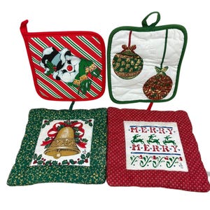 May include: Set of four Christmas-themed pot holders. One features a snowman, one has ornaments, one has a bell, and one says "Merry Merry" with reindeer.
