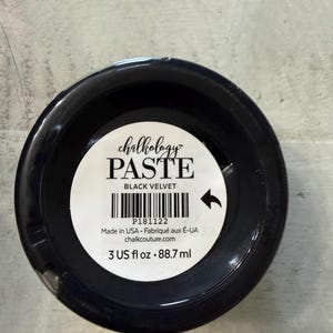 May include: A round container of Chalkology Paste in the color Black Velvet. The white label features the text Chalkology PASTE BLACK VELVET, a barcode, the product code P181122, and the volume measurement of 3 US fl oz or 88.7 ml.