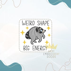 May include: A square embroidered patch featuring a gray and black raccoon illustration in the center, surrounded by four yellow stars. The text WEIRD SHAPE is embroidered above the raccoon, and BIG ENERGY is embroidered below in black thread.