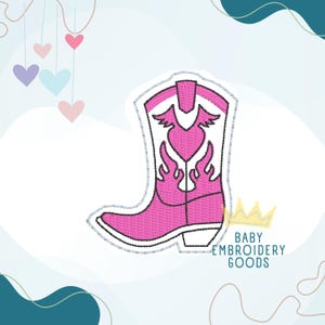 May include: A pink embroidered cowboy boot design with a heart and flame details. The boot has a silver outline and is set against a white background. The text "BABY EMBROIDERY GOODS" is visible.