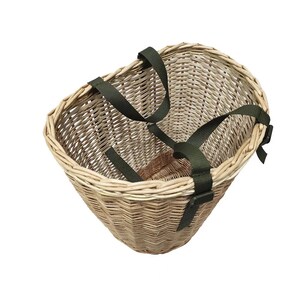 May include: A wicker basket with green straps. The basket is oval shaped and has a woven pattern. The straps are adjustable and have buckles.