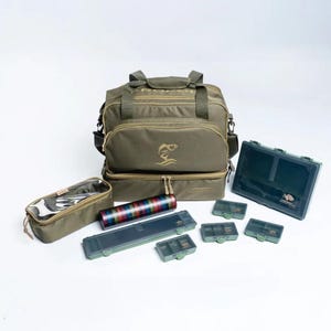 May include: An olive green fishing tackle bag with multiple compartments, a clear zippered pouch, and several small green tackle boxes. A multi-colored tube and a long, dark green box are also included.