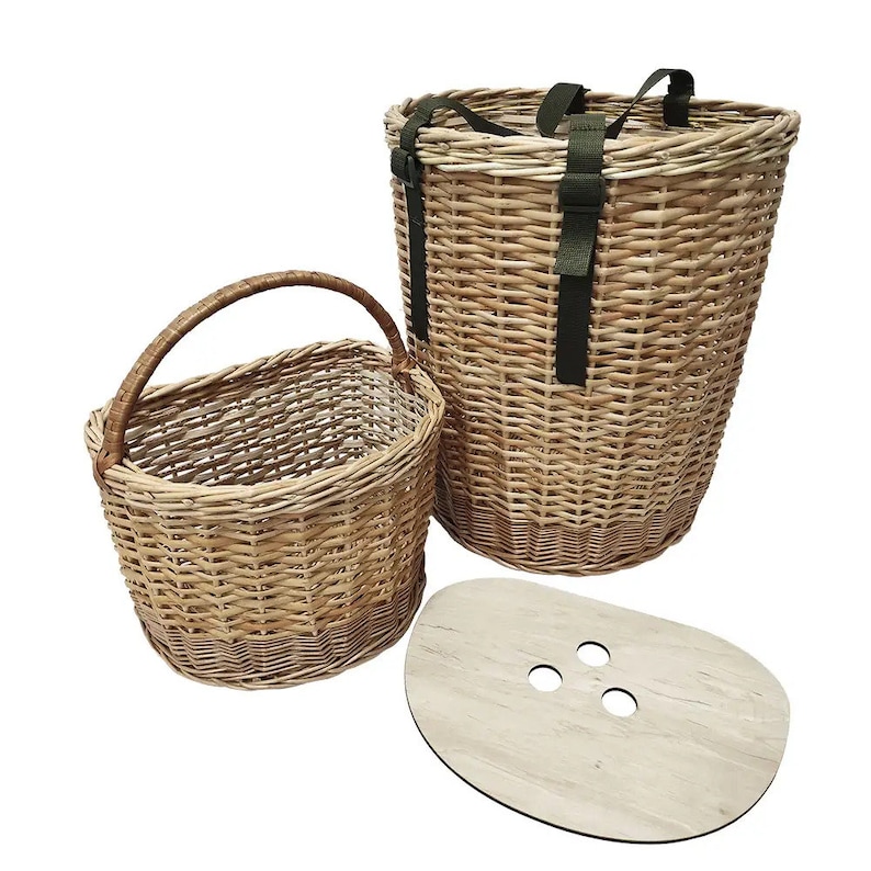 May include: Two woven wicker baskets with a wooden lid. The larger basket has two green straps and the smaller basket has a handle.