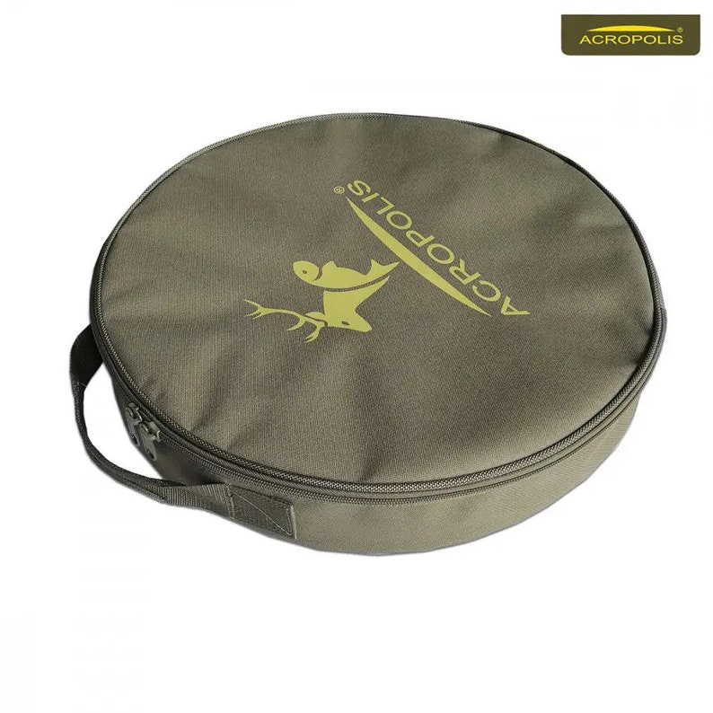 May include: A round, green canvas bag with a zipper closure and a handle. The bag has the word "ACROPOLIS" printed on it in a yellow font.