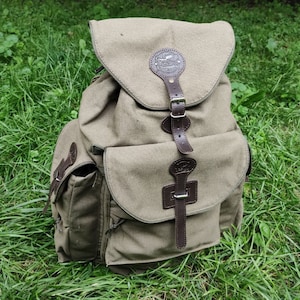 dayz tanned leather backpack Cowhide | Vegetable-Tanned Steel rivets and box stitching ensure the Rainier backpack will last a lifetime. Dayz Hunting Backpack - Etsy