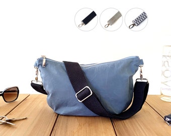 denim blue trendy practical half moon bag for everyday, casual roomy chest bag from waxed fabric, small soft and slouchy sling bag women