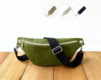 Soft green belly bag made from waxed cotton fabric (oilskin), vegan small crossbody banana bag with wide adjustable strap for women, men