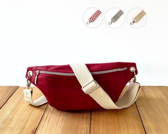Soft bum bag made from red waxed cotton fabric (oilskin), vegan small crossbody banana bag with wide adjustable strap for women, men