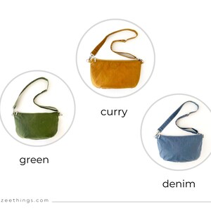 May include: Three small crossbody bags in different colors: green, curry, and denim. Each bag has a long adjustable strap.