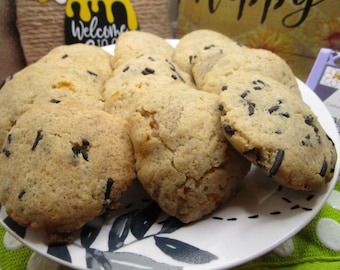May include: A plate of freshly baked cookies with chocolate sprinkles. The cookies are light brown and have a slightly crispy texture.