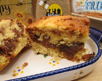 May include: Two slices of a swirl cake with a brown and white marbled pattern. The cake is on a white plate with blue and yellow floral designs.