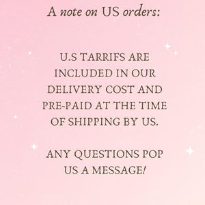 May include: A pink background with text that reads "A note on US orders: U.S TARRIFS ARE INCLUDED IN OUR DELIVERY COST AND PRE-PAID AT THE TIME OF SHIPPING BY US. ANY QUESTIONS POP US A MESSAGE! ROMANTASY DESIGNS."