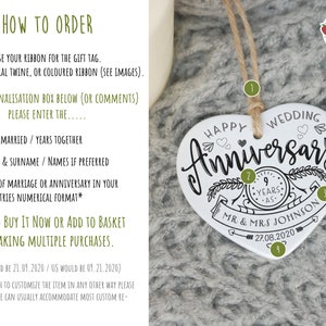 May include: White ceramic heart-shaped ornament with black text that reads "Happy Wedding Anniversary". The ornament features a wreath with the number "9" and the words "Years As" inside. Below the wreath, the text reads "Mr & Mrs Johnson" and "27.08.2020".