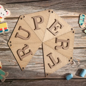 Rupert in bunting letters forming a circle
