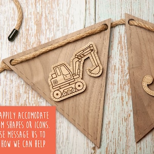 May include: Wooden banner with a brown background and a white rope. The banner has a cutout of a construction vehicle and the letter "J". The text "WE HAPPILY ACCOMODATE CUSTOM SHAPES OR ICONS. PLEASE MESSAGE US TO SEE HOW WE CAN HELP" is printed on a red background.