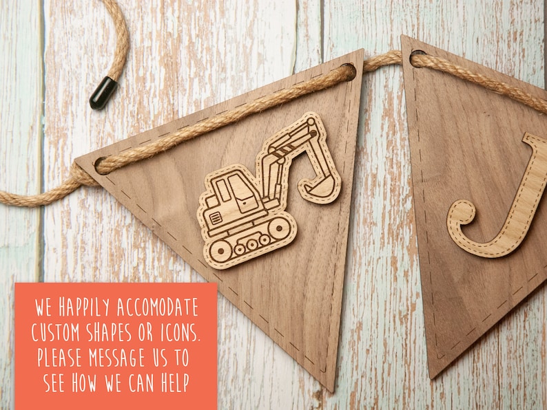 May include: Wooden banner with a brown background and a white rope. The banner has a cutout of a construction vehicle and the letter "J". The text "WE HAPPILY ACCOMODATE CUSTOM SHAPES OR ICONS. PLEASE MESSAGE US TO SEE HOW WE CAN HELP" is printed on a red background.