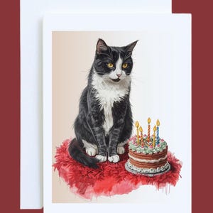 May include: A greeting card featuring a black and white cat with yellow eyes sitting on a red surface. A small birthday cake with lit candles sits in front of the cat. The card is white with a red border.
