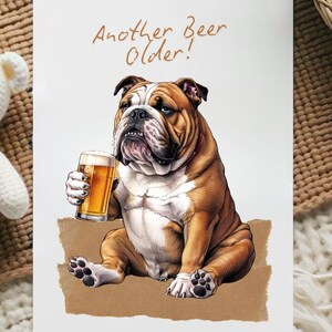 May include: A greeting card with a cartoon illustration of a bulldog holding a glass of beer. The text on the card reads "Another Beer Older!"