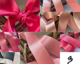 May include: Assortment of pink and peach satin ribbon spools. The ribbon is arranged in a basket and tied into a bow. The ribbon is available in various widths.  Berisfords Ribbons, Bows, Trimmings.