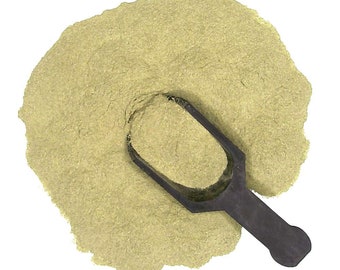 May include: A scoop of dried green powder, likely a spice or herb, on a white background. The powder is in a small pile with a scoop on top.