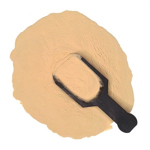 May include: A scoop of light brown powder with a black plastic scoop on top.