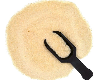 May include: A pile of light brown granulated sugar with a black plastic scoop.