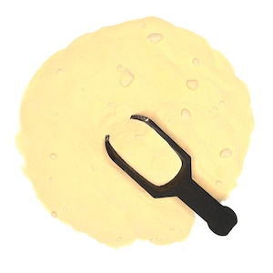 May include: A scoop of yellow powder with a black plastic scoop on top.