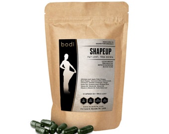 May include: A brown paper bag with a label that says "bodi SHAPEUP FAT LOST, TRIM DOWN" and lists ingredients. The bag contains dark green capsules.