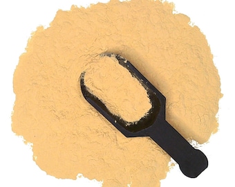 May include: A scoop of light brown powder, likely a spice or seasoning, with a black plastic scoop on top.